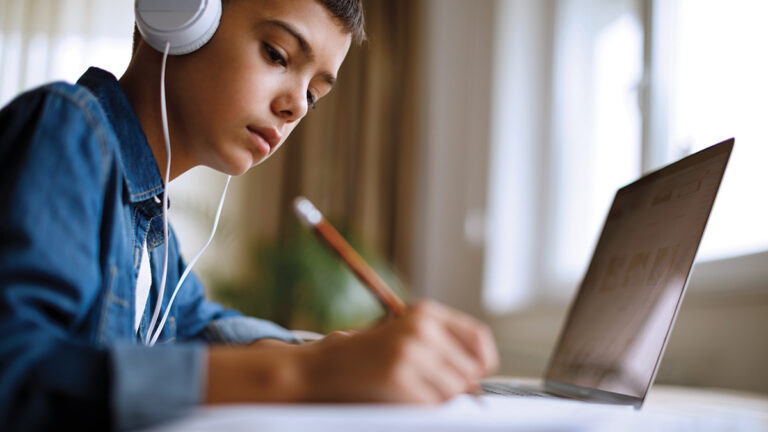 Kid listening to some music while studying